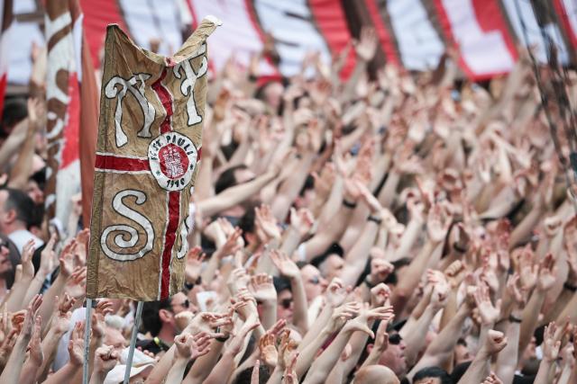 03 May 2026, Hamburg: FC St. Pauli fans cheer in the stands during the warm-up before the German Bundesliga soccer match between the FC St. Pauli and FSV Mainz 05 at the Millerntor Stadium. Photo: Christian Charisius/dpa - IMPORTANT NOTE: In accordance with the regulations of the DFL German Football League and the DFB German Football Association, it is prohibited to utilize or have utilized photographs taken in the stadium and/or of the match in the form of sequential images and/or video-like photo series.