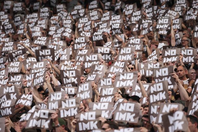 03 May 2026, Hamburg: FC St. Pauli fans hold up signs reading "NO IMK", to protest against the discussed tightening of security measures, during the German Bundesliga soccer match between the FC St. Pauli and FSV Mainz 05 at the Millerntor Stadium. Photo: Christian Charisius/dpa - IMPORTANT NOTICE: DFL and DFB regulations prohibit any use of photographs as image sequences and/or quasi-video.
