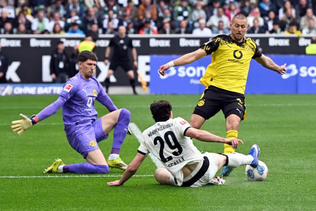 03 May 2026, North Rhine-Westphalia, Moenchengladbach: Moenchengladbach's Joe Scally (C) battles for the ball with Borussia Dortmund's goalkeeper Gregor Kobel and Waldemar Anton during the German Bundesliga soccer match between Borussia Moenchengladbach and Borussia Dortmund at Borussia-Park. Photo: Federico Gambarini/dpa - IMPORTANT NOTE: In accordance with the regulations of the DFL German Football League and the DFB German Football Association, it is prohibited to utilize or have utilized photographs taken in the stadium and/or of the match in the form of sequential images and/or video-like photo series.