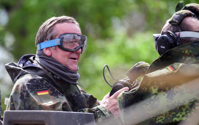 04 May 2026, Lower Saxony, Munster: German Minister of Defence, Boris Pistorius (L),goes on a ride on a German Military (Bundeswehr) tank. Photo: Philipp Schulze/dpa