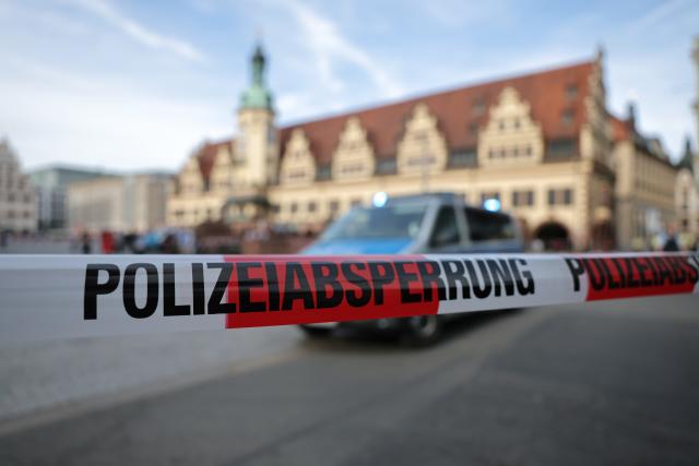 04 May 2026, Saxony, Leipzig: A police car is parked behind a police cordon at the spot where a car has driven into a group of people in Leipzig. Photo: Jan Woitas/dpa