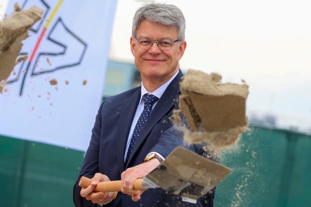 04 May 2026, North Rhine-Westphalia, Duisburg: Patrick Schnieder, German Minister of Transport, throws a load of sand into the air with a spade at the  ground-breaking ceremony for the controversial extension of the A59 bridge over the Ruhr and port area. Photo: Christoph Reichwein/dpa