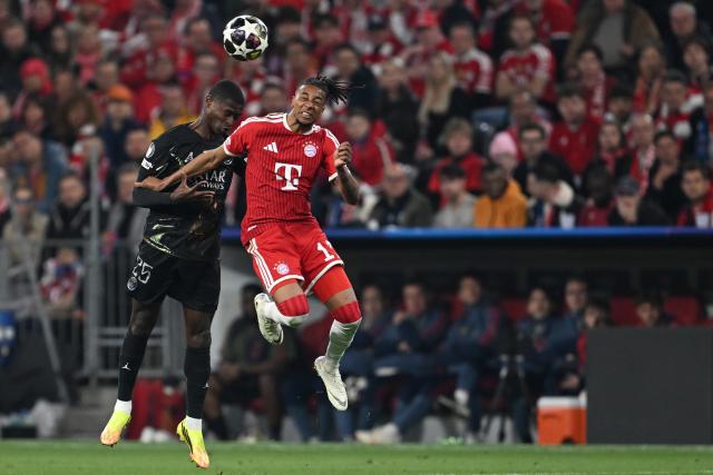 06 May 2026, Bavaria, Munich: Paris Saint-Germain's Nuno Mendes (L) and Bayern Munich's Michael Olise battle for a header during the UEFA Champions League semi-final, second leg soccer match between Bayern Munich and Paris Saint-Germain at the Allianz Arena. Photo: Sven Hoppe/dpa