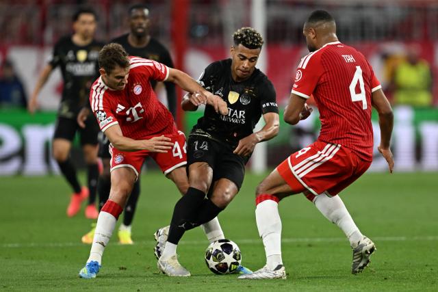 06 May 2026, Bavaria, Munich: Bayern Munich's Josip Stanisic (L) and Jonathan Tah in action against Paris Saint-Germain's Desire Doue during the UEFA Champions League semi-final, second leg soccer match between Bayern Munich and Paris Saint-Germain at the Allianz Arena. Photo: Sven Hoppe/dpa