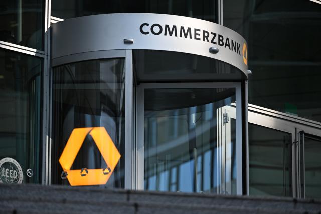 FILED - 16 March 2026, Hesse, Frankfurt/Main: The bank's name is displayed at the entrance to the Commerzbank Tower. Germany's Commerzbank plans to cut around 3,000 additional full-time jobs across the group, the DAX-listed lender says. Photo: Michael Brandt/dpa