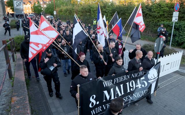08 May 2026, Mecklenburg-Western Pomerania, Demmin: Far-right extremists march through the city during a so-called "mourning march," while numerous counter-protesters force a change to the route. Every year on May 8, the party "Die Heimat" organizes the annual march in Demmin. Photo: Bernd Wüstneck/dpa