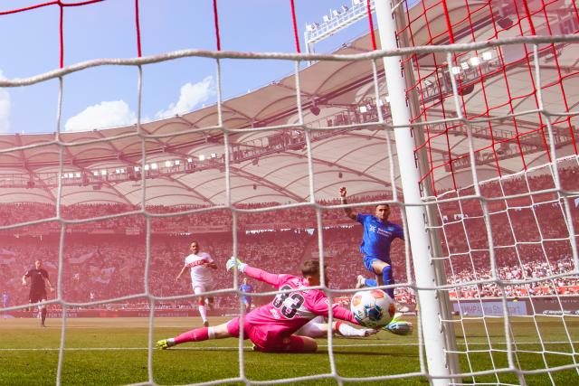 09 May 2026, Stuttgart: Bayer Leverkusen's Aleix Garcia (R) scores his side's first goal past Stuttgart goalkeeper Alexander Nuebel during the German Bundesliga soccer match between VfB Stuttgart and Bayer 04 Leverkusen at the MHPArena. Photo: Tom Weller/dpa - IMPORTANT NOTICE: DFL and DFB regulations prohibit any use of photographs as image sequences and/or quasi-video.