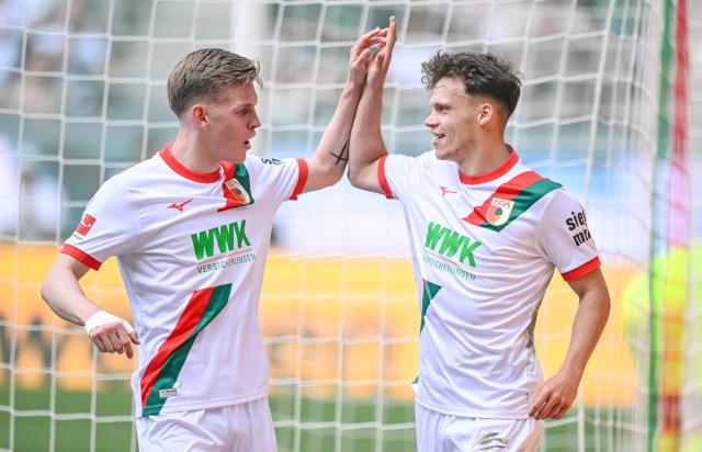 09 May 2026, Bavaria, Augsburg: Augsburg's Anton Kade (L) and Robin Fellhauer celebrate their second goal during the German Bundesliga soccer match between FC Augsburg and Borussia Moenchengladbach at the WWK-Arena. Photo: Harry Langer/dpa - IMPORTANT NOTICE: DFL and DFB regulations prohibit any use of photographs as image sequences and/or quasi-video.