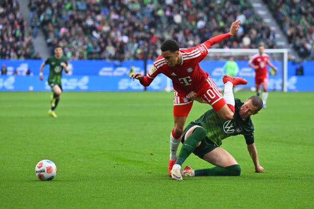 09 May 2026, Lower Saxony, Wolfsburg: Bayern Munich's Jamal Musiala (L) and Wolfsburg's Denis Vavro battle for the ball during the German Bundesliga soccer match between VfL Wolfsburg and Bayern Munich at the Volkswagen Arena. Photo: Swen Pförtner/dpa - IMPORTANT NOTICE: DFL and DFB regulations prohibit any use of photographs as image sequences and/or quasi-video.