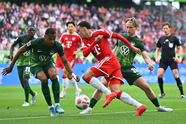 09 May 2026, Lower Saxony, Wolfsburg: Bayern Munich's Jamal Musiala and Wolfsburg's Patrick Wimmer in action during the German Bundesliga soccer match between VfL Wolfsburg and Bayern Munich at the Volkswagen Arena. Photo: Swen Pförtner/dpa - IMPORTANT NOTICE: DFL and DFB regulations prohibit any use of photographs as image sequences and/or quasi-video.