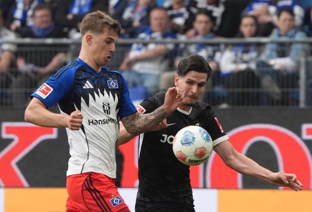 10 May 2026, Hamburg: Freiburg's Igor Matanovic and Hamburger's Luka Vuskovic battle for the ball during the German Bundesliga soccer match between Hamburger SV and SC Freiburg at Volksparkstadion. Photo: Marcus Brandt/dpa - IMPORTANT NOTE: In accordance with the regulations of the DFL German Football League and the DFB German Football Association, it is prohibited to utilize or have utilized photographs taken in the stadium and/or of the match in the form of sequential images and/or video-like photo series.