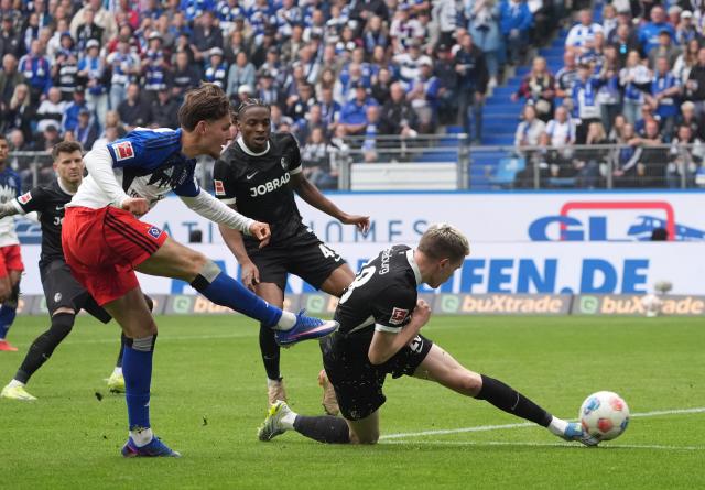 10 May 2026, Hamburg: Hamburger's Otto Stange (L) and Freiburg's Matthias Ginter battle for the ball during the 
German Bundesliga soccer match between Hamburger SV and SC Freiburg at Volksparkstadion. Photo: Marcus Brandt/dpa - IMPORTANT NOTE: In accordance with the regulations of the DFL German Football League and the DFB German Football Association, it is prohibited to utilize or have utilized photographs taken in the stadium and/or of the match in the form of sequential images and/or video-like photo series.