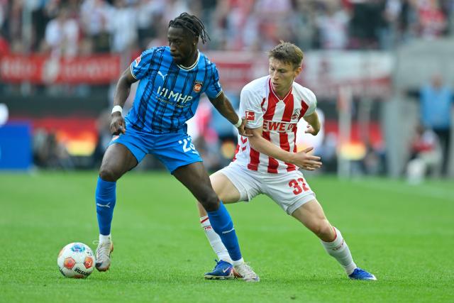 10 May 2026, North Rhine-Westphalia, Cologne: Heidenheim's Omar Traore and Cologne's Kristoffer Lund battle for the ball during the German Bundesliga soccer match between 1.FC Cologne and 1.FC Heidenheim at RheinEnergieStadion. Photo: Ulrich Hufnagel/dpa - IMPORTANT NOTE: In accordance with the regulations of the DFL German Football League and the DFB German Football Association, it is prohibited to utilize or have utilized photographs taken in the stadium and/or of the match in the form of sequential images and/or video-like photo series.