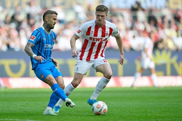 10 May 2026, North Rhine-Westphalia, Cologne: Heidenheim's Niklas Dorsch (L) and Cologne's Kristoffer Lund battle for the ball during the German Bundesliga soccer match between 1.FC Cologne and 1.FC Heidenheim at RheinEnergieStadion. Photo: Ulrich Hufnagel/dpa - IMPORTANT NOTE: In accordance with the regulations of the DFL German Football League and the DFB German Football Association, it is prohibited to utilize or have utilized photographs taken in the stadium and/or of the match in the form of sequential images and/or video-like photo series.