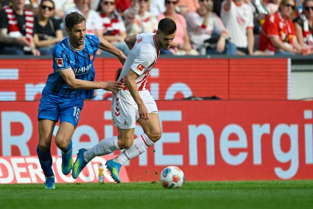 10 May 2026, North Rhine-Westphalia, Cologne: Heidenheim's Marvin Pieringer (L) and Cologne's Tom Krauss battle for the ball during the German Bundesliga soccer match between 1.FC Cologne and 1.FC Heidenheim at RheinEnergieStadion. Photo: Ulrich Hufnagel/dpa - IMPORTANT NOTE: In accordance with the regulations of the DFL German Football League and the DFB German Football Association, it is prohibited to utilize or have utilized photographs taken in the stadium and/or of the match in the form of sequential images and/or video-like photo series.