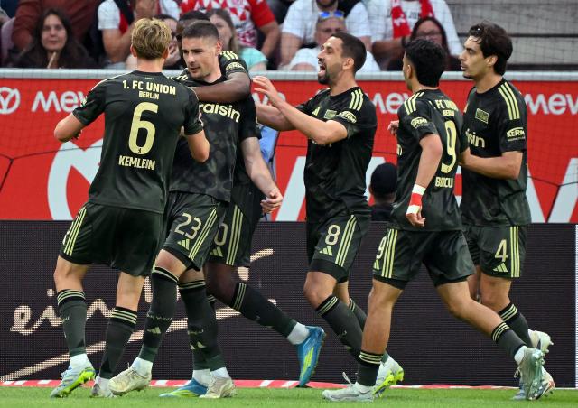 10 May 2026, Rhineland-Palatinate, Mainz: Union Berlin's celebrate their side's first goal scored by Andrej Ilic during the German Bundesliga soccer match between FSV Mainz 05 and 1.FC Union Berlin at Mewa Arena. Photo: Torsten Silz/dpa - IMPORTANT NOTE: In accordance with the regulations of the DFL German Football League and the DFB German Football Association, it is prohibited to utilize or have utilized photographs taken in the stadium and/or of the match in the form of sequential images and/or video-like photo series.