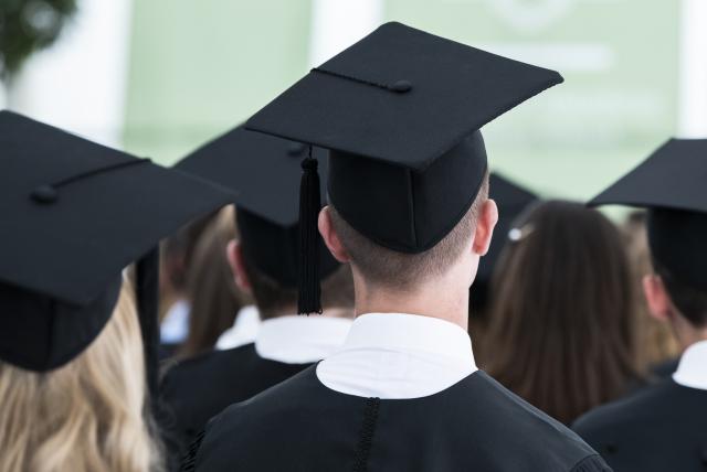 FILED - 03 August 2019, Baden-Wuerttemberg, Mannheim: FILE PHOTO - Graduates sit in a tent on the premises of the University of Mannheim during a Master's graduate party. Photo: Silas Stein/dpa