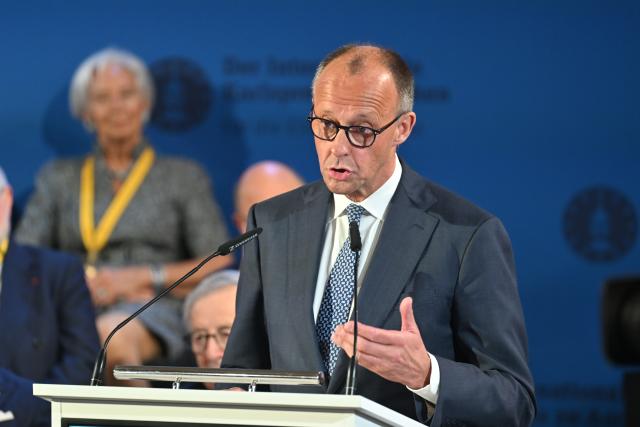 14 May 2026, North Rhine-Westphalia, Aachen: German Chancellor Friedrich Merz delivers a speech during the Charlemagne Prize award ceremony in Aachen City Hall. Former President of the European Central Bank (ECB), Mario Draghi, is to be awarded the Charlemagne Prize 2026. Photo: Henning Kaiser/dpa
