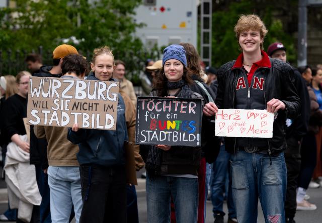 15 May 2026, Bavaria, Wuerzburg: Demonstrators protest against Chancellor Merz's visit at the 104th German Catholic Congress, holding signs reading "Würzburg doesn't want them in the cityscape" and "Daughters for a colorful cityscape". Photo: Sven Hoppe/dpa - ATTENTION: editorial use only and only if the credit mentioned above is referenced in full