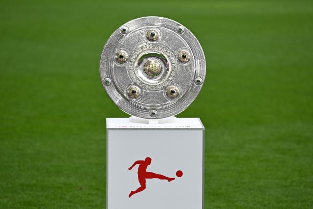 16 May 2026, Bavaria, Munich: The championship trophy is displayed in the stadium before the German Bundesliga soccer match between Bayern Munich and 1. FC Cologne. Photo: Sven Hoppe/dpa - IMPORTANT NOTICE: DFL and DFB regulations prohibit any use of photographs as image sequences and/or quasi-video.