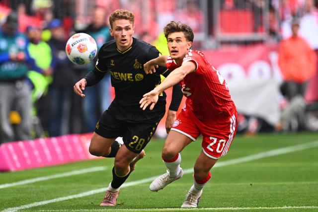 16 May 2026, Bavaria, Munich: Bayern Munich's Tom Bischof (R) and Cologne's Sebastian Sebulonsen battle for the ball during the German Bundesliga soccer match between Bayern Munich and 1. FC Cologne at Allianz Arena. Photo: Tom Weller/dpa - IMPORTANT NOTICE: DFL and DFB regulations prohibit any use of photographs as image sequences and/or quasi-video.