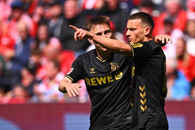 16 May 2026, Bavaria, Munich: Cologne's Said El Mala (R) celebrates scoring his side's first goal with teammate Kristoffer Lund during the German Bundesliga soccer match between Bayern Munich and 1. FC Cologne at Allianz Arena. Photo: Tom Weller/dpa - IMPORTANT NOTICE: DFL and DFB regulations prohibit any use of photographs as image sequences and/or quasi-video.