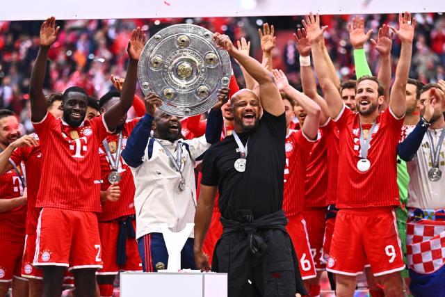 16 May 2026, Bavaria, Munich: Bayern Munich coach Vincent Kompany celebrates winning the German championship with the trophy after the German Bundesliga soccer match between Bayern Munich and 1. FC Cologne at Allianz Arena. Photo: Tom Weller/dpa - IMPORTANT NOTICE: DFL and DFB regulations prohibit any use of photographs as image sequences and/or quasi-video.