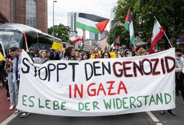 16 May 2026, Hesse, Frankfurt_Main: People carry a banner that reads "Stop the Genocide in Gaza-Long Live the Resistance" 
during a march through downtown to mark the Palestinian Nakba Day. Photo: Boris Roessler/dpa