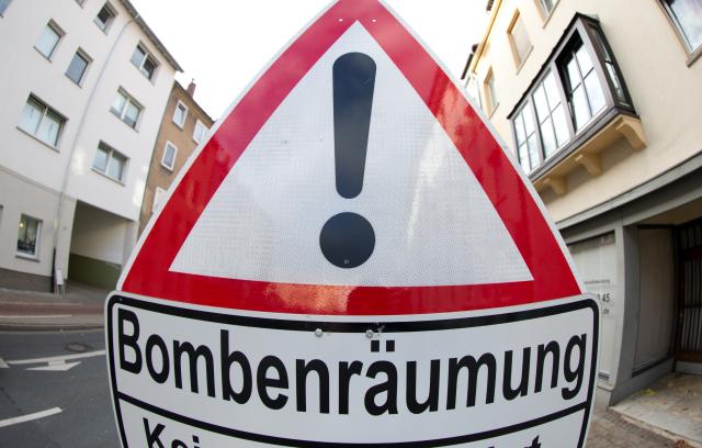 FILED - 27 October 2013, Lower Saxony, Osnabrueck: FILWE PHOTO - A traffic sign indicates that a bomb is being defused. Some 30,000 people have been told to evacuate their homes after an unexploded World War II bomb was found in the south-western German city of Pforzheim, police said on Sunday. Photo: Friso Gentsch/dpa