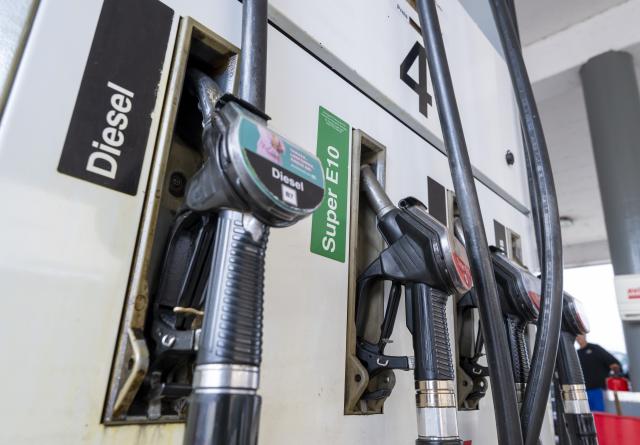FILED - 02 March 2026, Bavaria, Munich: FILE PHOTO - Fuel nozzles hang in their holders at a gas station. Photo: Peter Kneffel/dpa