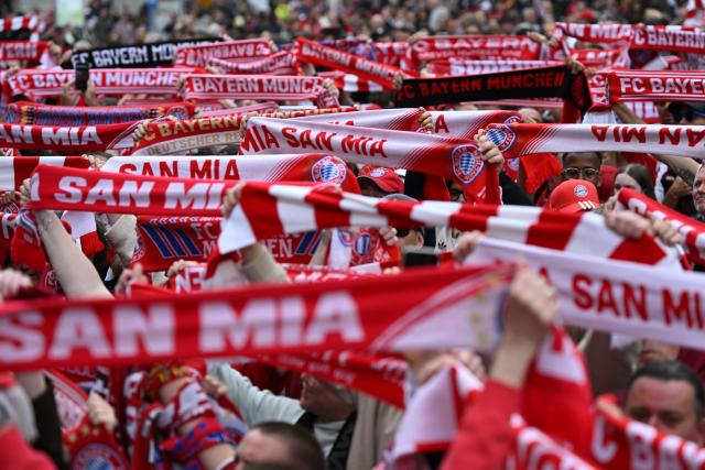 17 May 2026, Bavaria, Munich: Bayern Munich fans hold their scarves aloft in Marienplatz before the arrival of FC Bayern players to celebrate the German Bundesliga championship on the balcony of City Hall. Photo: Sven Hoppe/dpa