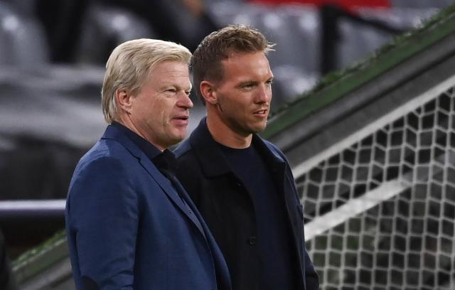 FILED - 29 September 2021, Bavaria, Munich: FILE PHOTO - Munich coach Julian Nagelsmann and former Bayern board member Oliver Kahn (L) talk before the UEFA Champions League soccer match between Bayern Munich and Dynamo Kyiv at the Allianz Arena. Photo: Sven Hoppe/dpa