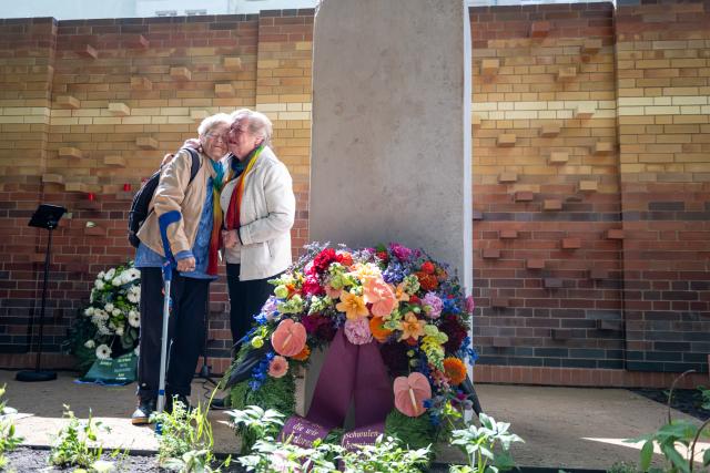 17 May 2026, Berlin: Two women stand next to the Kissing Stone at the dedication of the new burial and memorial site for queer people, organized by Schwulenberatung Berlin, at St. Matthaeus Churchyard. Photo: Fabian Sommer/dpa
