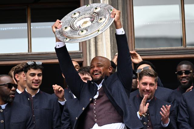17 May 2026, Bavaria, Munich: Bayern Munich coach Vincent Kompany celebrates with the trophy on the town hall balcony during the German Bundesliga championship celebrations at Marienplatz. Photo: Sven Hoppe/dpa