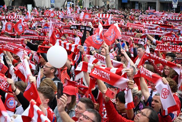 17 May 2026, Bavaria, Munich: Bayern Munich fans wave flags and scarves during Bayern Munich's celebrations of the German Bundesliga championship title at Marienplatz in Munich. Photo: Felix Hörhager/dpa