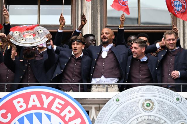 17 May 2026, Bavaria, Munich: Bayern Munich coach Vincent Kompany stands with team members on the town hall balcony during celebrations for their German Bundesliga championship title at Marienplatz in Munich. Photo: Sven Hoppe/dpa