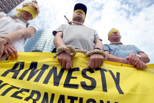 FILED - 28 July 2013, Berlin: FILE PHOTO - Amnesty International activists stage a protest at Potsdamer Platz in Berlin against the surge in executions. Photo: picture alliance / dpa
