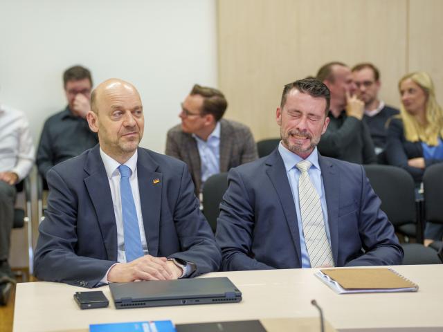 18 May 2026, Hesse, Wiesbaden: Robert Lambrou (L) and Andreas Lichert, co-chairmen of the Alternative for Germany (AfD) in Hesse, sit in the courtroom before the start of the hearing in the administrative court. The classification of the Hessian AfD as a suspected right-wing extremist organization by the State Office for the Protection of the Constitution (LfV) is being heard before the Wiesbaden Administrative Court. With the second lawsuit, the AfD is also defending itself against the fact that the LfV had publicly communicated its decision on the classification. Photo: Andreas Arnold/dpa Pool/dpa