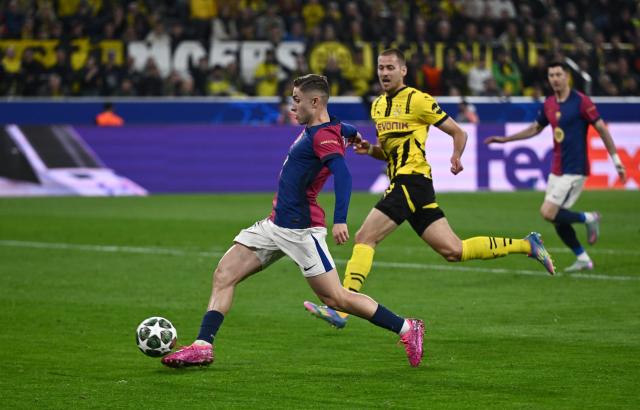FILED - 15 April 2025, North Rhine-Westphalia, Dortmund: FILE PHOTO - Barcelona's Fermin Lopez and Dortmund's Waldemar Anton battle for the ball during the UEFA Champions League quarter-final second leg soccer match between Borussia Dortmund and FC Barcelona at the Signal Iduna Park. Photo: Bernd Thissen/dpa