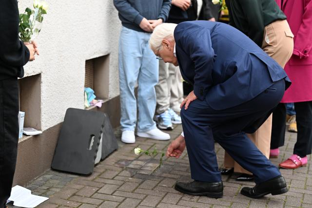 18 May 2026, Dorsten: German President Frank-Walter Steinmeier, lays white roses at the Stolpersteine in memory of the victims of National Socialism. Steinmeier's visit to Dorsten marks the start of the nationwide Day of the Basic Law. Photo: Federico Gambarini/dpa