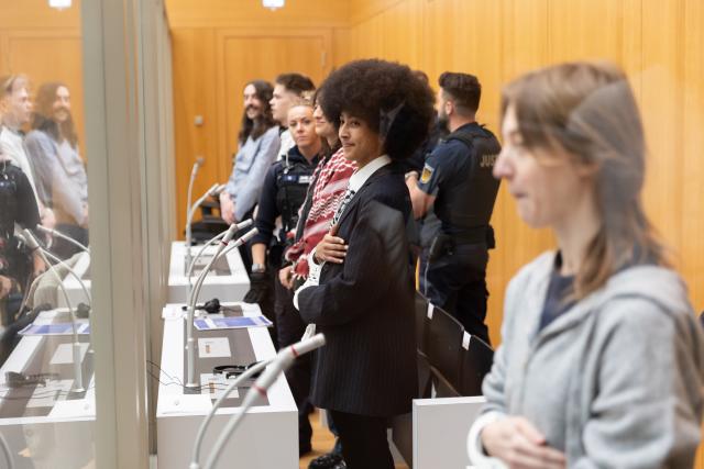 FILED - 27 April 2026, Baden-Wuerttemberg, Stuttgart: FILE PHOTO - Pro-Palestinian activists stand in the courtroom before the start of their trial in Stammheim. According to the indictment, they broke into an Israeli defense contractor in Ulm at night, destroyed a large amount of inventory there, spray-painted the walls, and caused millions in damage. Photo: Julian Rettig/dpa