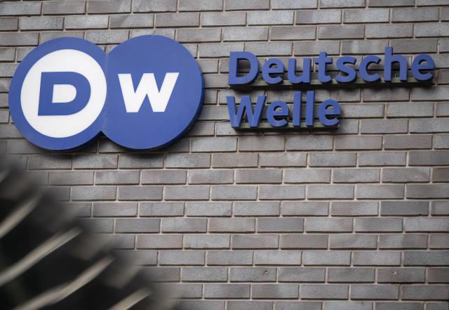 FILED - 22 March 2024, Berlin: FILE PHOTO - The logo of the international broadcaster Deutsche Welle is pictured at the entrance to the broadcaster's headquarters in Berlin. Photo: Monika Skolimowska/dpa