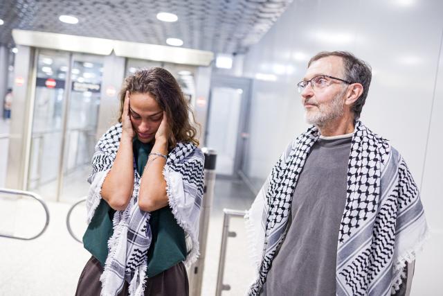 23 May 2026, Lower Saxony, Langenhagen: Nesrin Zeaiter and Uwe Sander stand in front of their supporters at Hanover Airport. The two activists from the Gaza aid flotilla, who were deported from Israel to Turkey, have returned to Germany. Photo: Moritz Frankenberg/dpa