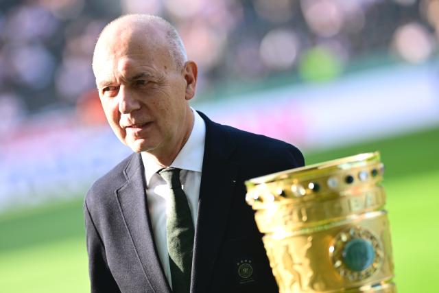 23 May 2026, Berlin: Bernd Neuendorf, President of the German Football Association (DFB), poses for a photo next to the DFB Cup ahead of the German DFB Cup Final soccer match between Bayern Munich andVfB Stuttgart at Berlin Olympic Stadium. Photo: Sebastian Gollnow/dpa