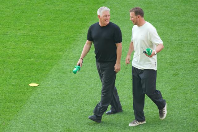 23 May 2026, Berlin: Bastian Schweinsteiger (L) and Germany national team coach Julian Nagelsmann walk on the pitch ahead of the German DFB Cup Final soccer match between Bayern Munich and VfB Stuttgart at Berlin Olympic Stadium. Photo: Soeren Stache/dpa