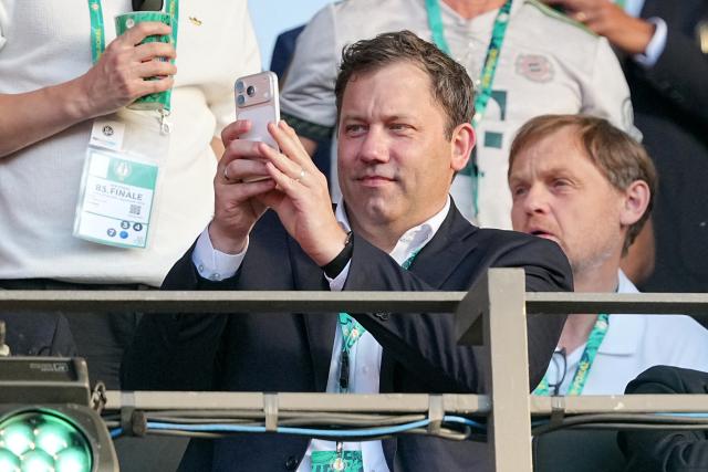 23 May 2026, Berlin: Lars Klingbeil, Germany's Minister of Finance, watches from the stands with his smartphone in hand during the German DFB Cup Final between Bayern Munich and VfB Stuttgart at the Olympic Stadium in Berlin. Photo: Michael Kappeler/dpa