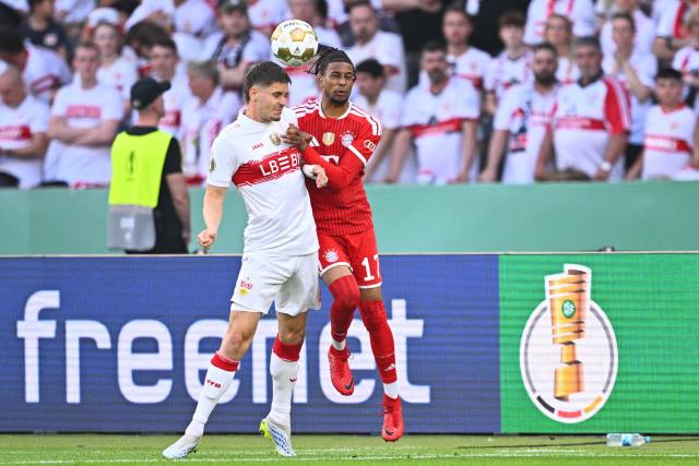 23 May 2026, Berlin: Stuttgart's Ramon Hendriks (L) and Bayern Munich's Michael Olise battle for the ball during the German DFB Cup Final between Bayern Munich and VfB Stuttgart at the Olympic Stadium in Berlin. Photo: Tom Weller/dpa