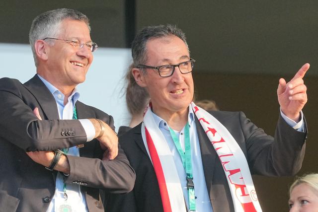 23 May 2026, Berlin: Herbert Heiner, President of Bayern Munich (L), and Cem Oezdemir, Minister-President of Baden-Wuerttemberg, watching from the stands during the German DFB Cup Final between Bayern Munich and VfB Stuttgart at the Olympic Stadium in Berlin. Photo: Michael Kappeler/dpa