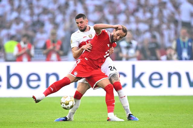 23 May 2026, Berlin: Bayern Munich's Harry Kane (R) and Stuttgart's Jeff Chabot battle for the ball during the German DFB Cup Final between Bayern Munich and VfB Stuttgart at the Olympic Stadium in Berlin. Photo: Tom Weller/dpa