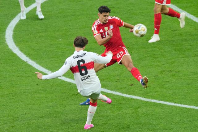 23 May 2026, Berlin: Stuttgart's Angelo Stiller (L) and Bayern Munich's Aleksandar Pavlovic battle for the ball during the German DFB Cup Final between Bayern Munich and VfB Stuttgart at the Olympic Stadium in Berlin. Photo: Soeren Stache/dpa